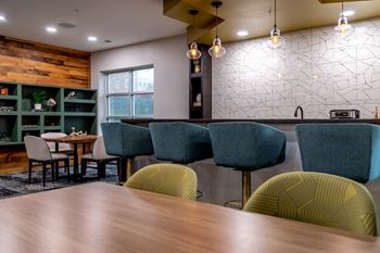 a dining room with a wooden table and chairs at 310 at Nulu Apartments-Student, Louisville